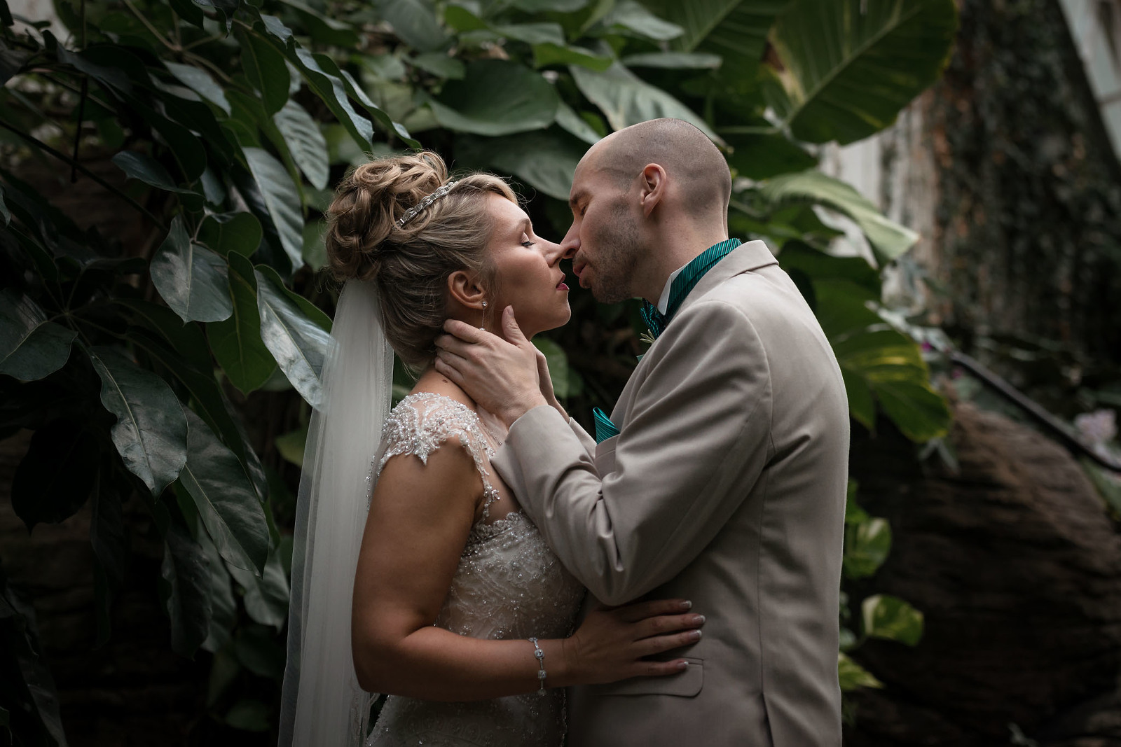 Bride and groom embracing and kissing, Botanical Conservatory Fort Wayne Indiana wedding photography, Kasey Wallace Photography